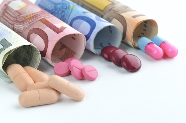 medical pills and tablets in euro bank notes money as a symbol of health costs